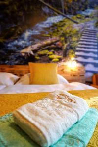 uma toalha branca sentada em cima de duas camas em Hotel Raj em Dedinky