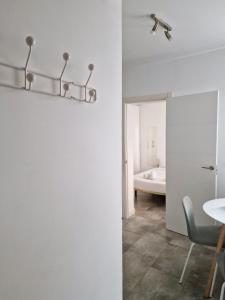 a white room with a table and a chair at San Buenaventura Vistillas apartamento para dos in Madrid
