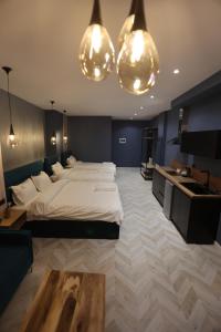 a bedroom with a large bed and two lights at B.G Luxury Suites in Korçë