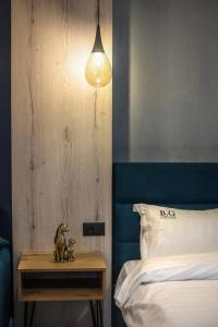 a bedroom with a bed and a table with two figurines on it at B.G Luxury Suites in Korçë