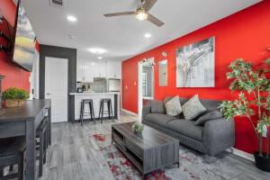 a living room with a couch and a kitchen at Amazing Living I Sleeps 14 WI-FI Parking Free Gym in Houston