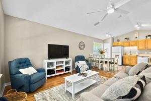 a living room with a couch and a tv at Peaceful Pearl Retreat- 5 Minutes to Downtown, 10 Minutes to Beach in Saint Augustine