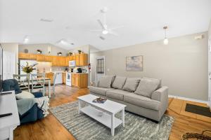 a living room with a couch and a table at Peaceful Pearl Retreat- 5 Minutes to Downtown, 10 Minutes to Beach in Saint Augustine