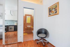 a black chair in a room with a mirror at Memo Apartment in Bologna +29 photos