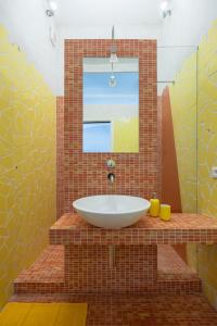 a bathroom with a white sink and a mirror at Memo Apartment in Bologna
