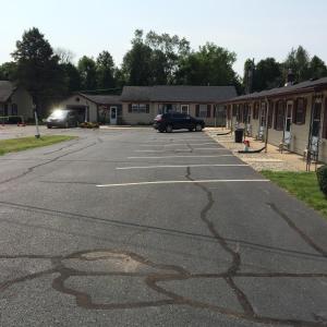 an empty parking lot with a car parked in it at Howards Motel in Marshall