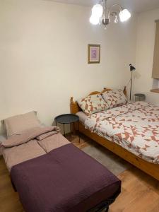 a bedroom with a bed and a small table at Cozy Family River View Flat Near The Beach Seaside in Rīga