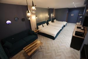 a bedroom with a bed and a couch in it at B.G Luxury Suites in Korçë