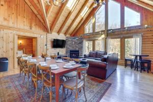 a dining room and living room with a table and chairs at Private Hot Tub and Fire Pit Log Cabin in Blakeslee in Blakeslee