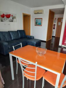 a living room with a table and a couch at Rocha Tower Apartments in Portimão