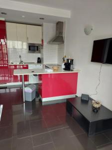 a kitchen with a red and white counter top at Rocha Tower Apartments in Portimão