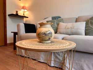 a vase sitting on a table in a living room at Le Margériaz 32m Balcon vue in Aillon-le-Jeune