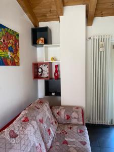 a living room with a bed and a radiator at River House in Porlezza