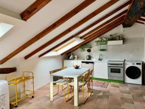 a kitchen with a table and chairs in a room at FANTASTI-Casa al Lago in Colonno