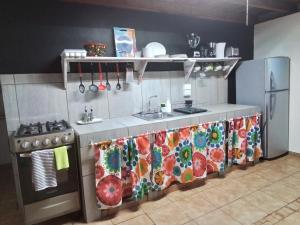 a kitchen with a sink and a stove at Brisas del Caribe, casa 5 in Puerto Viejo
