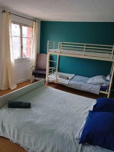 a bedroom with two bunk beds and a window at Gîte à Châtelus, au calme dans l'Allier in Châtelus