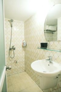 a bathroom with a sink and a shower with a mirror at Central Cozy apartment - Beer street 201#301 in Hanoi