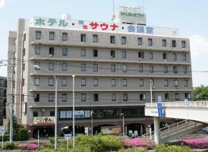 a building with a sign on the side of it at Hotel Kajigaya Plaza in Kawasaki