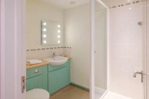 a bathroom with a toilet and a sink and a shower at Flat 2 Mawgan Porth Golf Club in Mawgan Porth