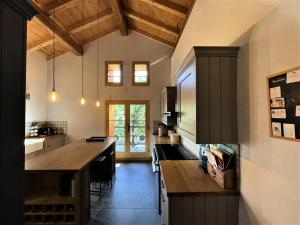 a kitchen with a wooden counter top in a room at Résidence Stone Shed - 5 Pièces pour 8 Personnes 981 in Saint-Marcel
