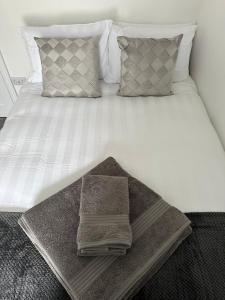 a bed with a tray with two towels on it at Surprise sea view cosy apartment in Morecambe