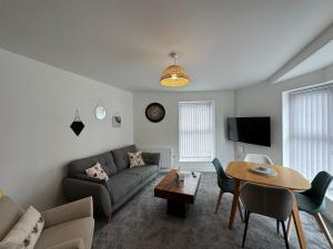 a living room with a couch and a table at Surprise sea view cosy apartment in Morecambe