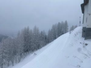 a snow covered road with trees and a house at Al Colle in Ateleta