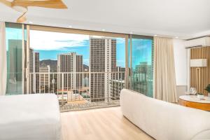 a living room with a view of the city at Ocean Retreat: Remodeled Pacific Monarch Haven in Honolulu