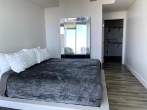 ein Schlafzimmer mit einem Bett und einen Flur mit einem Spiegel in der Unterkunft San Diego Convention Center Padres Ocean Views SD Zoo in San Diego