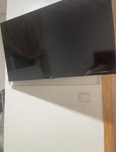 a microwave sitting on top of a refrigerator at شقة لقضاء عطلة مميزة بمدينة الفنيدق Apartment for a special holiday in Fnideq in Riffiene