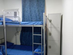 a room with two bunk beds and a ladder at Hostel Friends Dubai in Dubai