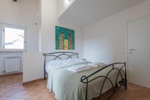a white bedroom with a bed and a window at Juliet’s Paradise - Rooftop Terrace in Verona