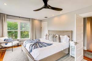a bedroom with a bed and a ceiling fan at Lush West Palm Beach Getaway with Backyard Oasis! in West Palm Beach +23 photos