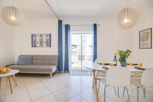 a living room with a couch and a table and chairs at Old Town 2BR 50m Ocean w/ AC Wi-Fi Parking Terrace in Albufeira