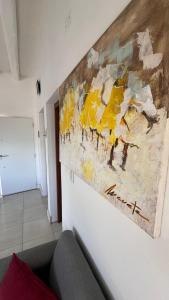 a painting hanging on a wall in a room at Tierras del Malbec 1 in Ciudad Lujan de Cuyo