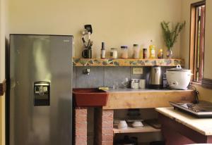 a kitchen with a stainless steel refrigerator and a counter at Cabina de montaña in San José