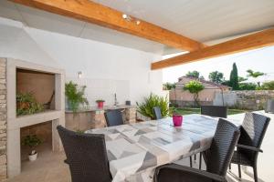 stół jadalny i krzesła na patio w obiekcie Holiday Home Fradelani w mieście Žminj