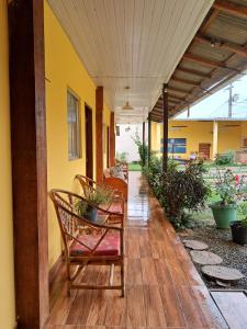 a porch with chairs and plants on a building at Pousada Luar de Alter in Alter do Chao