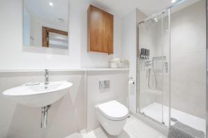a bathroom with a sink and a toilet and a shower at Kula London - Tower Hill in London