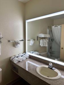 a bathroom with a sink and a large mirror at Sure Stay Plus by Best Western Twentynine Palms Joshua Tree in Twentynine Palms