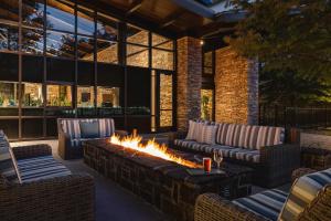 a patio with couches and a fire pit at The Woodlands Resort, Curio Collection by Hilton in The Woodlands