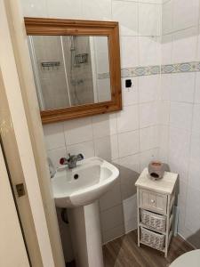 a bathroom with a sink and a mirror at Suite double room in Tottenham. in London