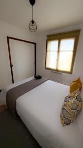 سرير أو أسرّة في غرفة في appartement L'OLIVIER