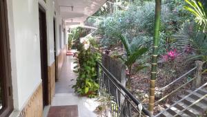 an empty hallway with a balcony with plants at Downing Street inn a perfect homestay in Port Blair