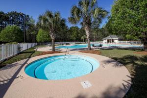 a swimming pool in a yard with a swimming pool at Palmetto Paradise, SC in Pawleys Island