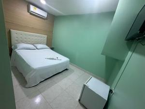 Säng eller sängar i ett rum på HOTEL NUEVO ARIZONA