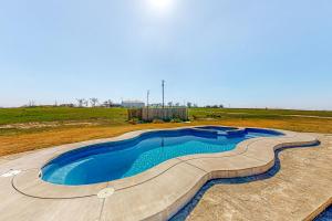 a swimming pool in the middle of a field at Wine Down Acres in Cameron
