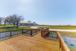 a large wooden deck with a house in the background at Wine Down Acres in Cameron