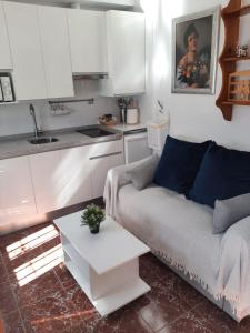 ein Wohnzimmer mit einem Sofa und einer Küche in der Unterkunft Aires de Grazalema in Prado del Rey