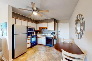 a kitchen with a table and a ceiling fan at Stay Salty in Myrtle Beach